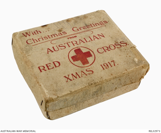 cardboard box with red cross logo on it